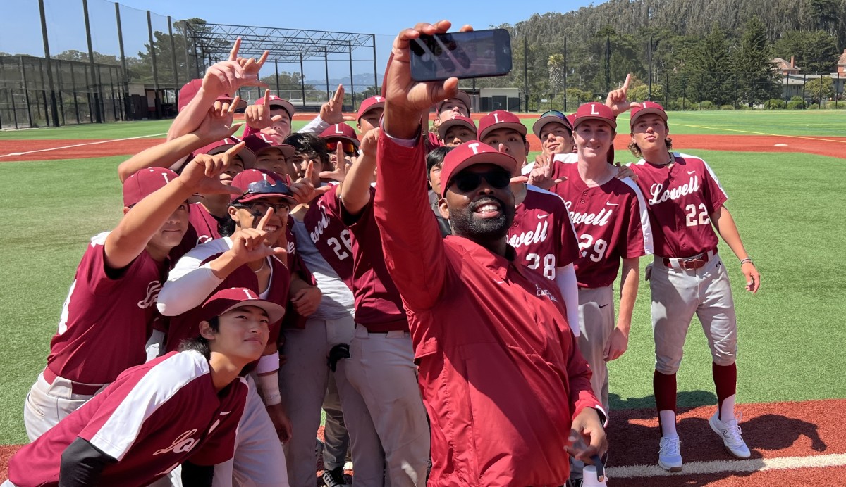 Lowell principal Dr. Michael Jones takes selfie with his champion Cardinals after Saturday's 4-0 win over University at Paul Goode Field. Photo: Mitch Stephens