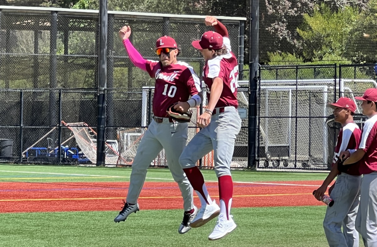 Lowell's Angelo  Ornelas-Rafael (10) and Ander Rogers (22) enjoy a leaping fist bump following Saturday's championship win at Paul Goode Field. Photo: Mitch Stephens