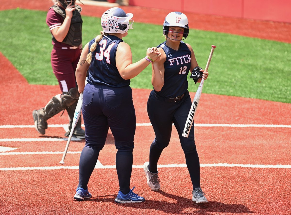 Austintown Fitch shortstop Ayla Ray (No. 12) shares a moment with catcher McKenna Hogan as Hogan heads up to bat in the 2023 Division I state semifinals against Lebanon. (Photo by Jeff Harwell)