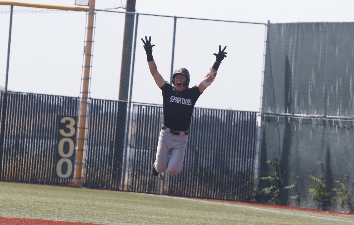 Hank Tripaldi leaps for glee rounding first base following his game-winning grand slam in the top of the seventh inning of De La Salle's 11-8 win at Valley Christian.undefinedPhoto: Noah Glosson/West Coast Preps. 