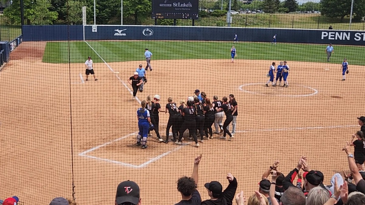 Tri-Valley catcher Brittany Rice approaches home plate as her teammates wait for her after she hit a two-run home run in the sixth inning of the PIAA Class 1A state championship game Friday. (photo: Ryan Isley)