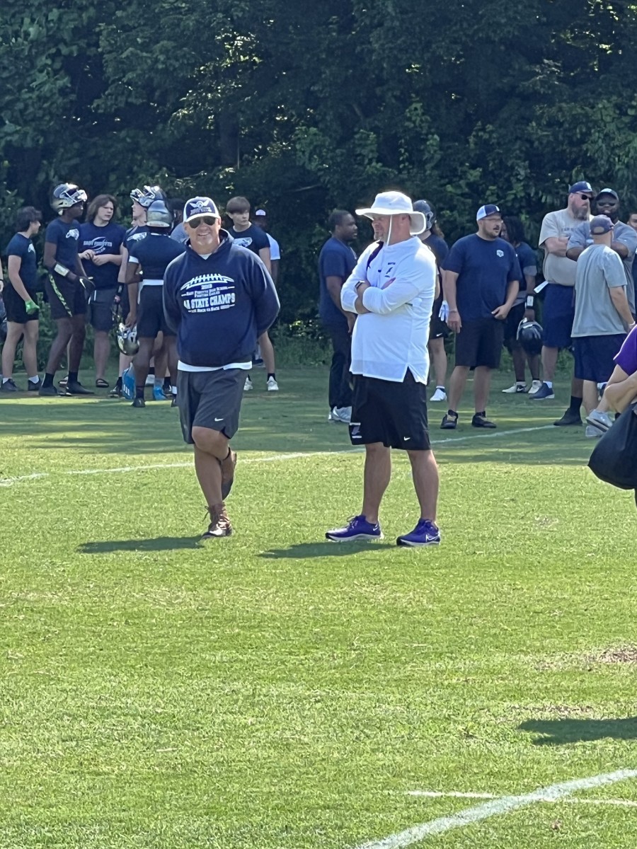 Todd Willert (left) of East Forsyth and Erik Westberg (right) of Northern Guilford chat following their teams' 7 on 7 at West Forsyth.