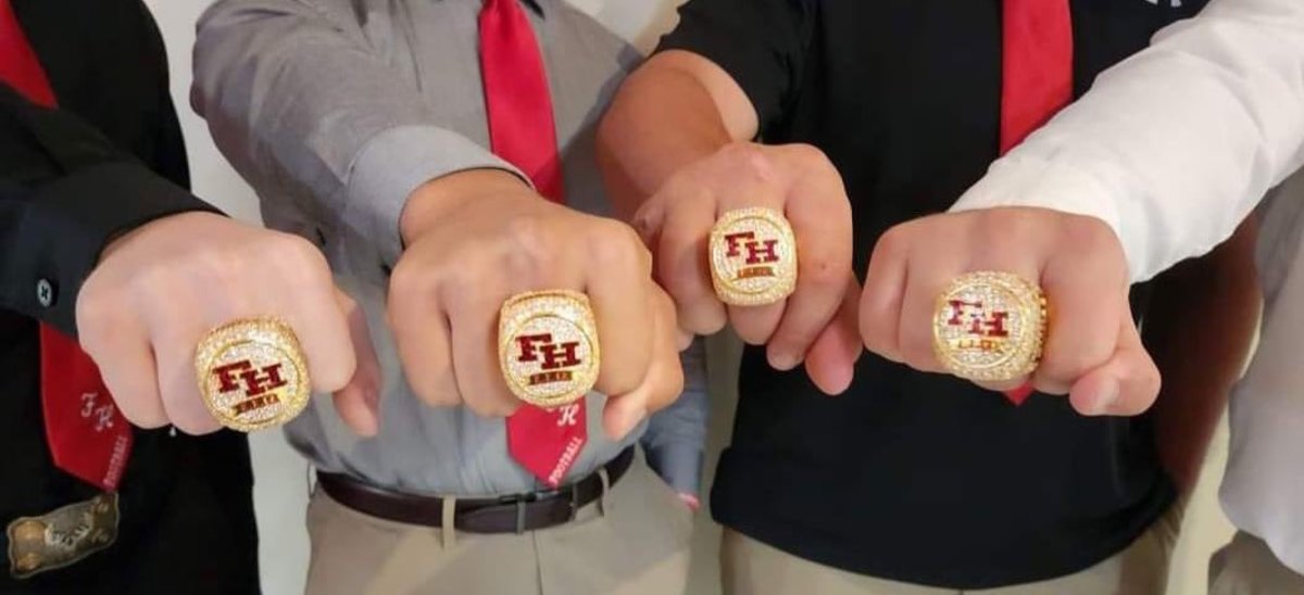 Fort Hill football players show off their latest state championship rings.