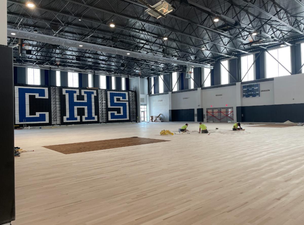 Inside the gym as work is done to complete the flooring.
