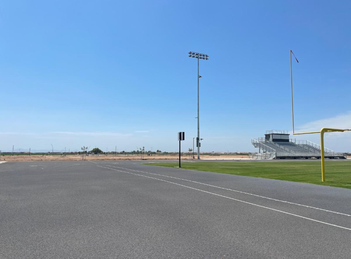 The dirt lot will soon be the site of a large turf athletic field for football with both home and visiting bleachers. Visiting teams will be able to share the dual-sided press box from the grass field. 