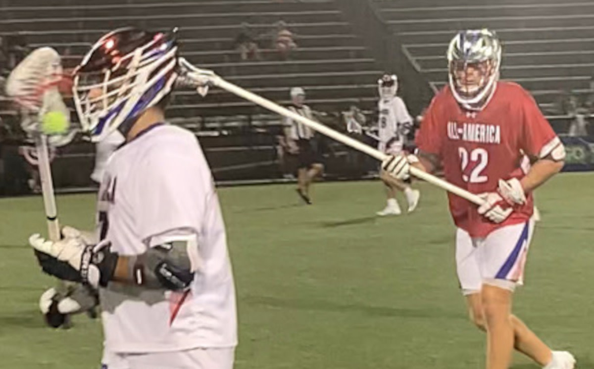 Patrick Crogan (Massachusetts’ Lexington) looks for an offensive opening as the North's long-stick defender by AJ Larkin (Loyola) closes in to challenge.