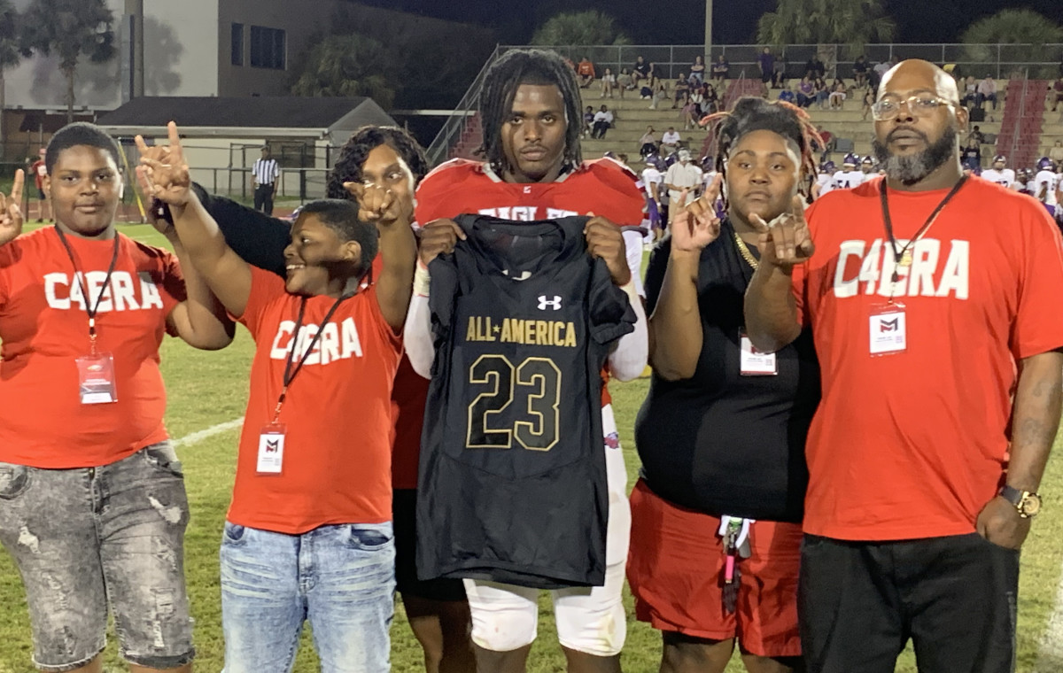 Edgewater star CJ Baxter, Jr., who is committed to the University of Texas, was honored at halftime of Thursday's 40-0 win over Timber Creek. While Baxter showed off his All-America jersey, his family flashed the Hook'em Horns sign.