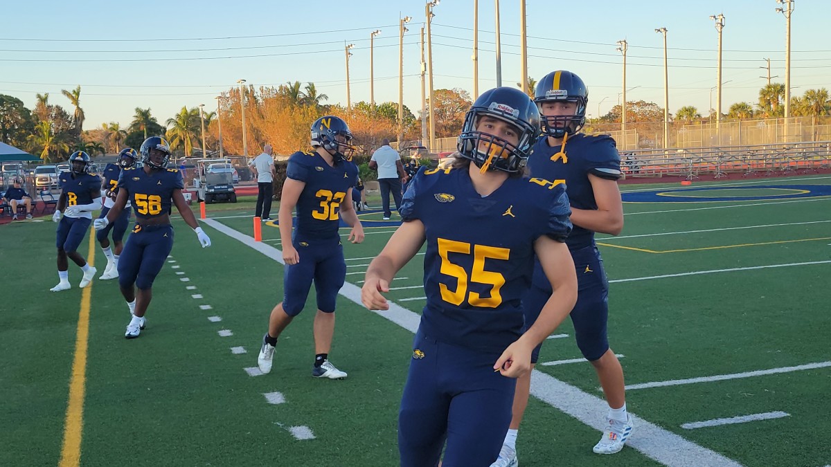 Members of the Naples football team goes through pregame warmups prior to their game with Barron Collier on Friday. Both teams were idle for more than a week after the destruction caused by Hurricane Ian and only returned to practice on Tuesday.