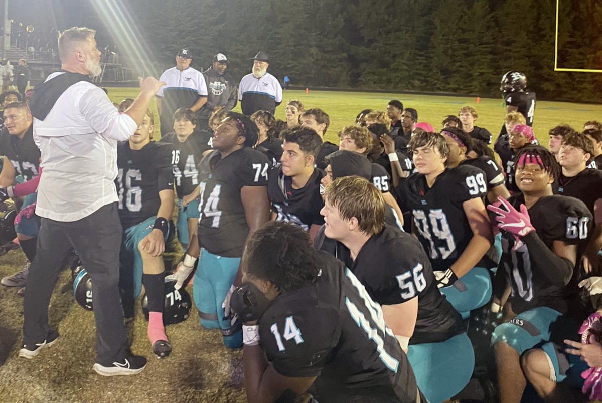 Reagan head coach Josh McGee addresses his team following Friday's thrilling, 42-39, win over West Forsyth.