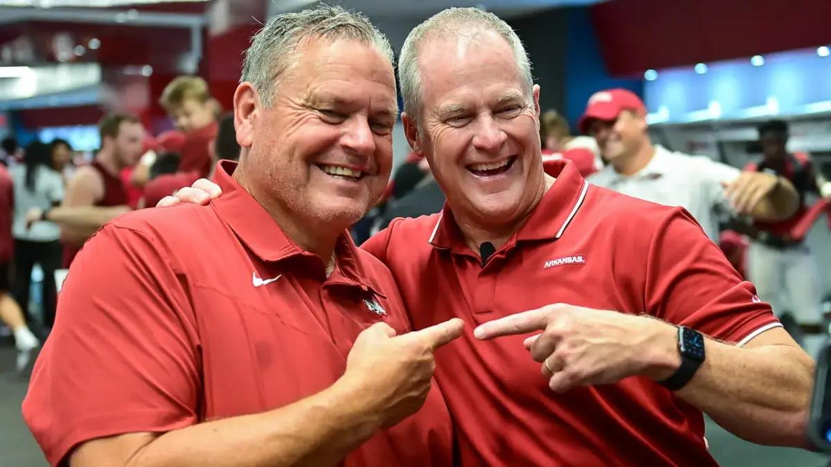 (Photo by UA athletics communications) Hunter Yurachek, right, pictured with Arkansas head football coach Sam Pittman, has made an impact on his three sons as he has embarked on a long career in athletics administration. 
