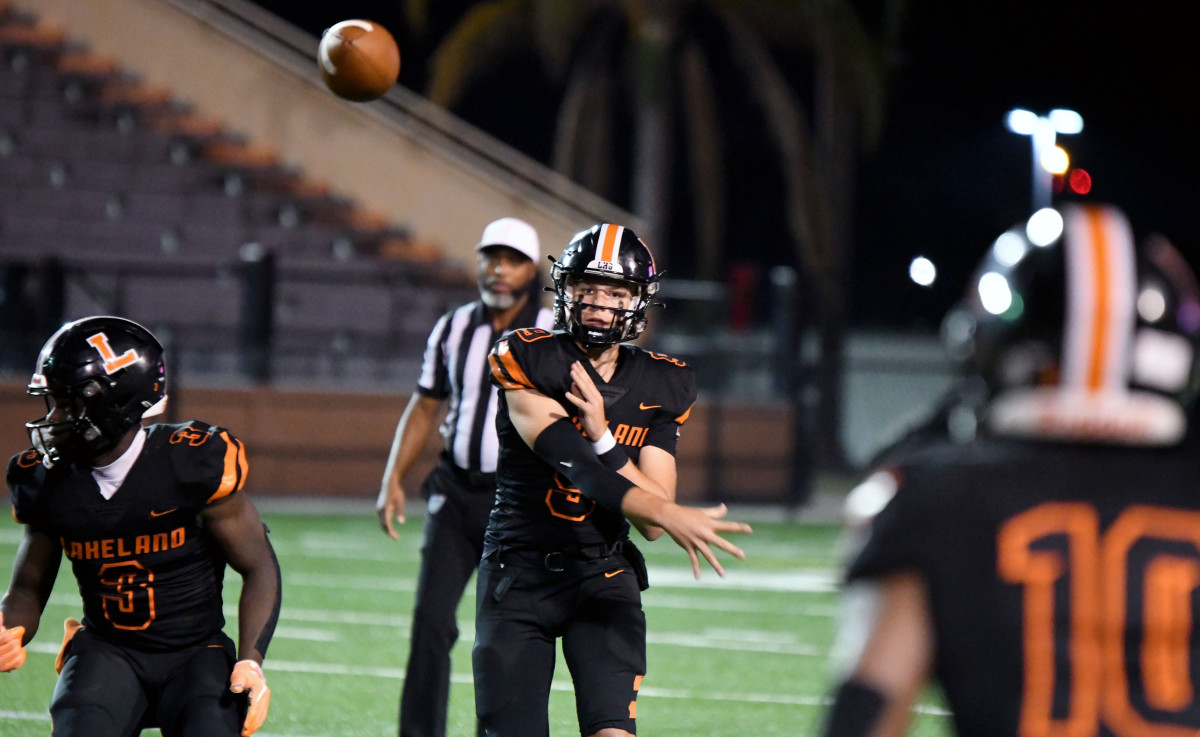 Lakeland senior quarterback Zach Pleuss fires a pass over the middle to Tyler Williams (10) during a matchup of ranked teams on Friday at Bryant Stadium in Lakeland. The Dreadnoughts beat Clearwater Academy International 44-6.