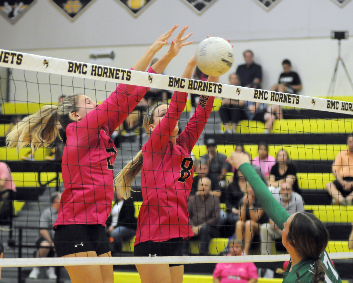 Bishop Moore blockers Leah McDonald (2) and Jaide Wirth (8) block Lake Placid's Sarah Sherley during the second set of the Hornets' 25-5, 25-12, 25-6 Region 2-4A quarterfinal victory. McDonald and Wirth each had two block assists.