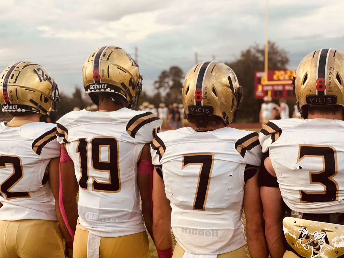 The Bishop Moore football team wore a No. 8 red decal on the back of their helmets in honor of East River quarterback Nick Miner, who was killed last week when his vehicle was struck while he was attempting to help a stranded motorist.