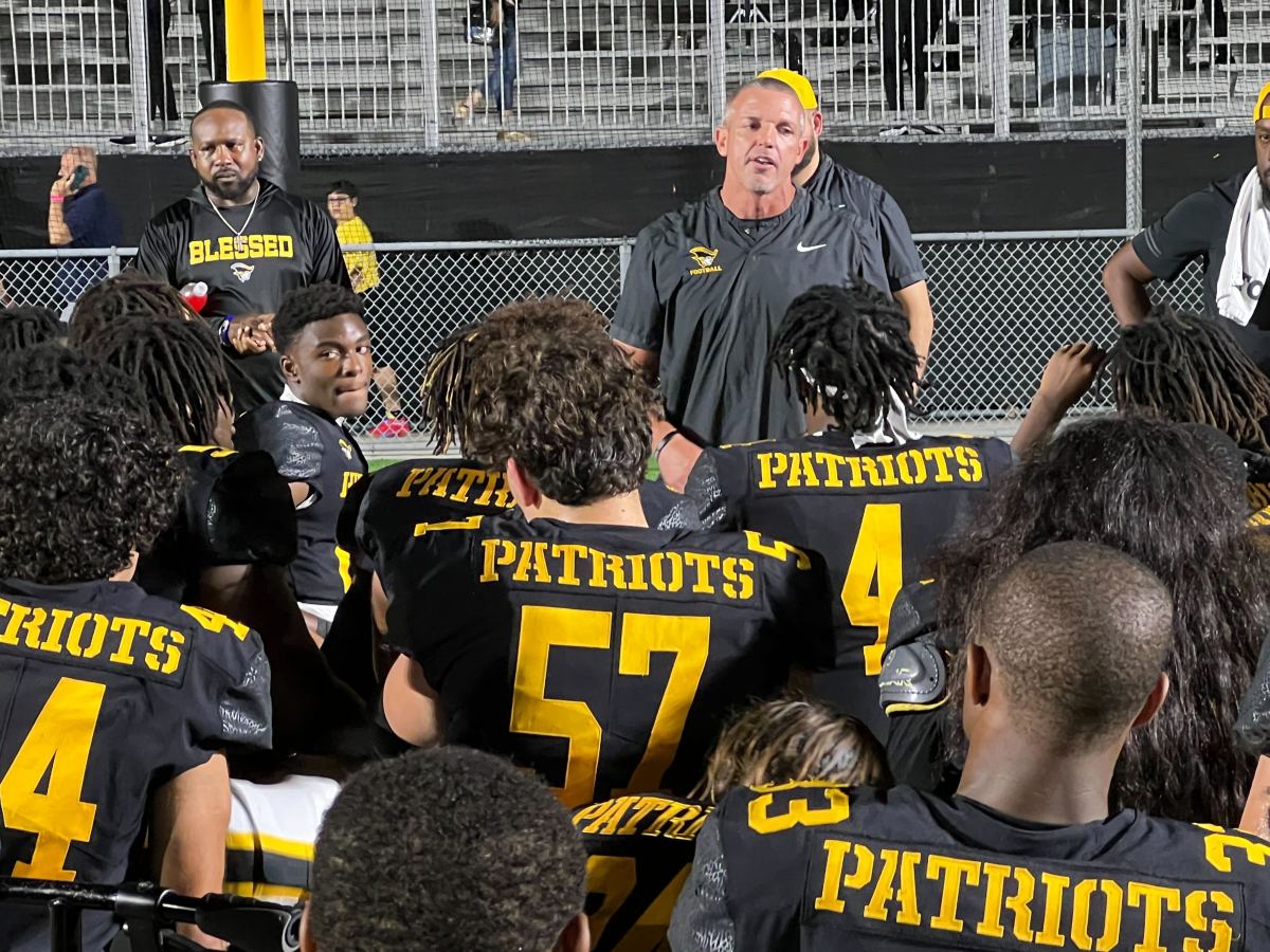 American Heritage head coach Mike Smith speaks to his troops following their 63-0 win over Hallandale.