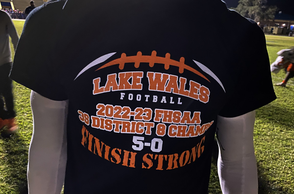 A Lake Wales player wears a Highlanders’ 3S District 8 championship t-shirt that was unpacked following the District 8 championship game win at Auburndale on Friday at Bruce Canova Stadium.
