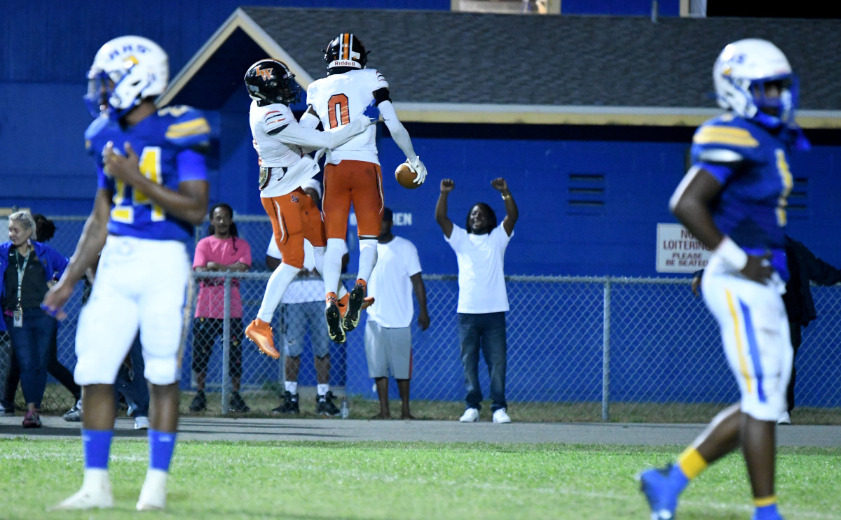 Carlos Mitchell and Diyante Landrum celebrate Landrum’s 43-yard touchdown catch in the final seconds of the 3S District 8 championship game at Auburndale on Friday at Bruce Canova Stadium.