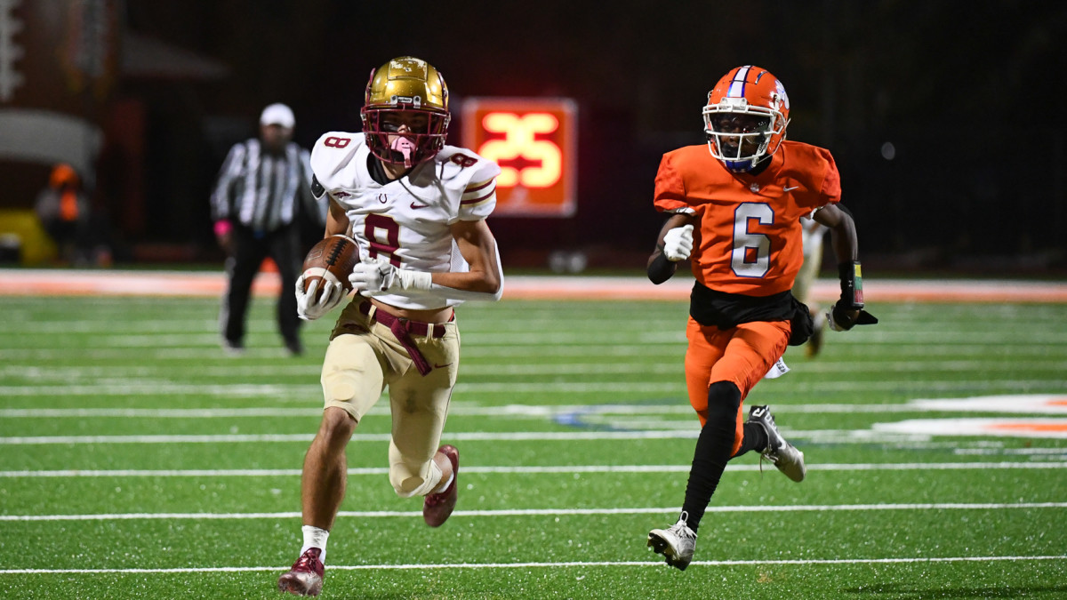 Brookwood's Bryce Dopson (8) races towards the end zone as Parkwood's Sean Ferguson gives chase.