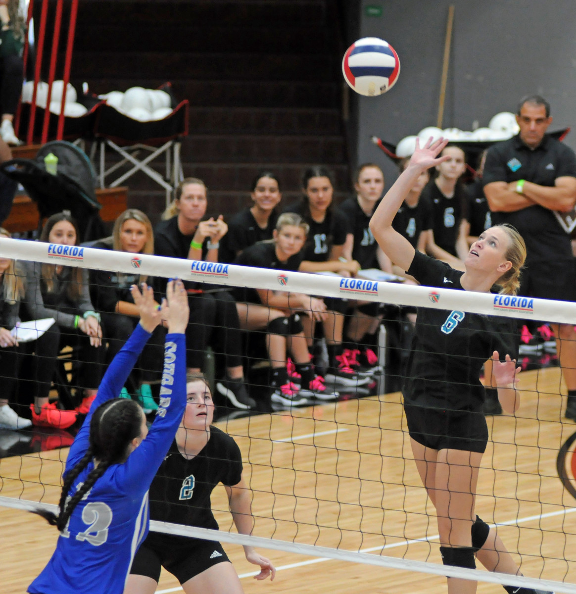 Jensen Beach senior Haley Handlen (6) tries to attack past the block of Barron Collier's Scarlett Martz (12) during their Class 5A volleyball final. Handlen had seven kills in the Falcons' victory.