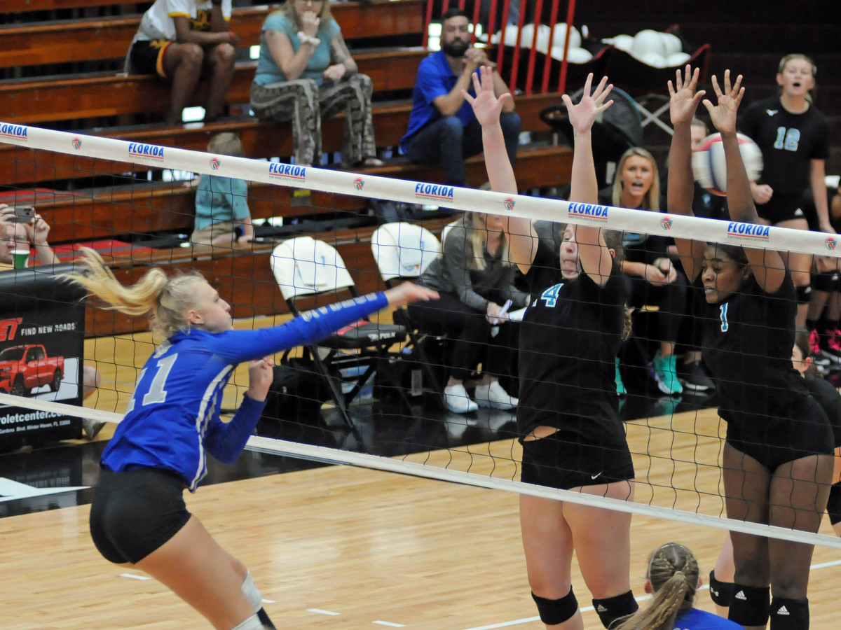 Barron Collier's Kendra Pruitt tries to hit around the block of Lilly Parr (4) and Kiosha Smith (1) during their Class 5A volleyball final. Pruitt had 16 kills.