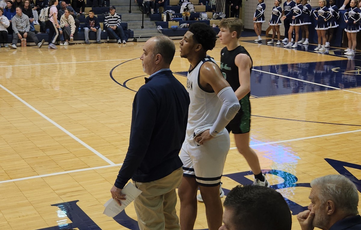 Archbishop Hoban head coach T.K. Griffith and senior Jonas Nichols talk during a game on January 30, 2024