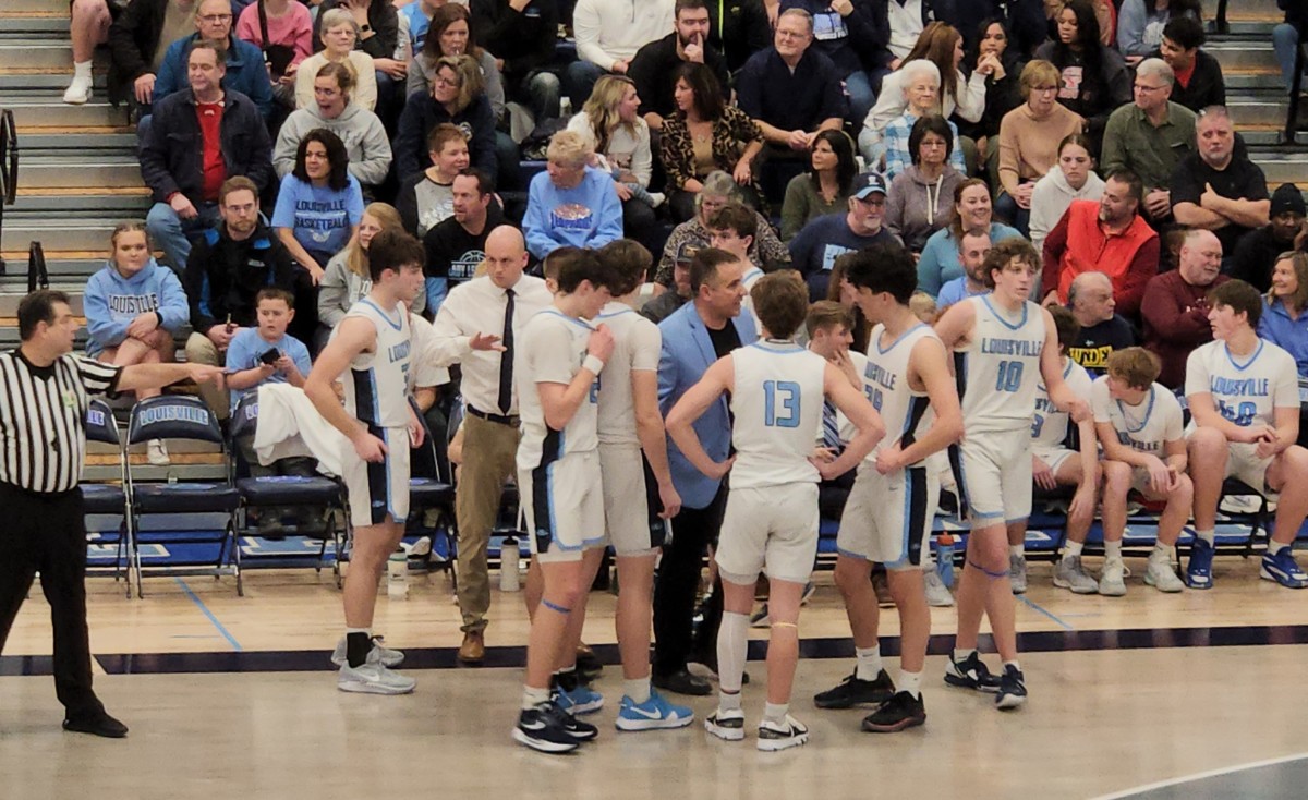 Louisville head coach Tom Siegfried talks to his team during a timeout in a win over Canton McKinley on February 2, 2024.