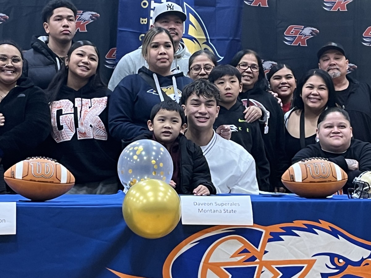 Graham-Kapowsin QB Daveon Superales signs with Montana State University football in front of family at school gymnasium Wednesday on Signing Day.