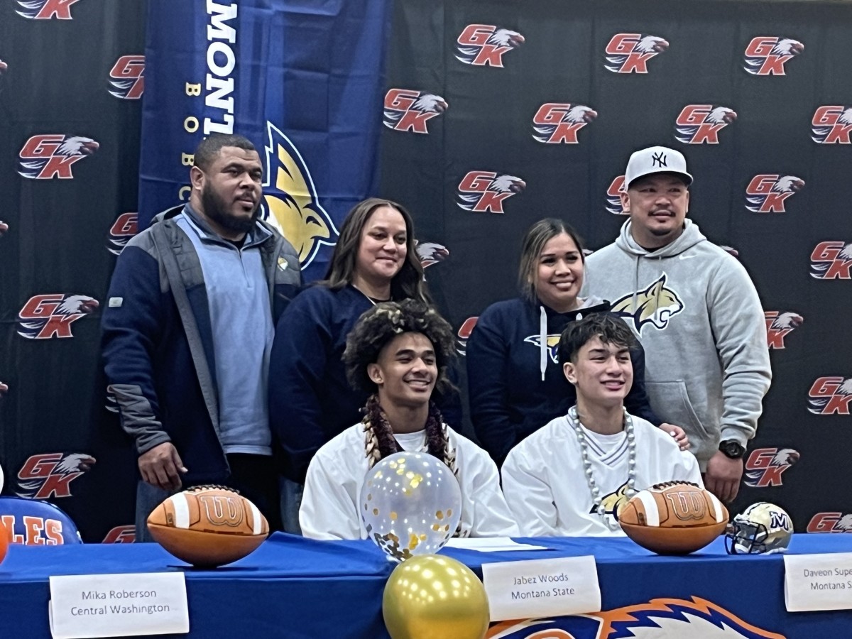 Graham-Kapowsin QB Daveon Superales and WR Jabez Woods sign with Montana State University football in front of family at school gymnasium Wednesday on Signing Day.