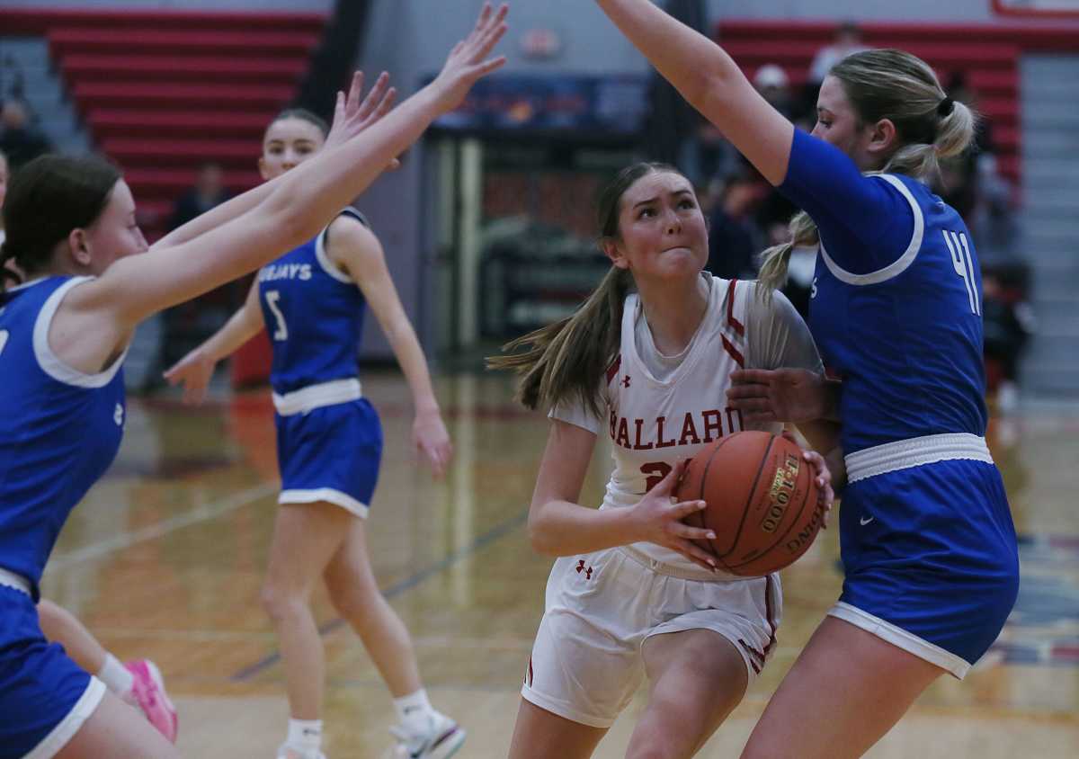 Iowa girls high school basketball: Ballard forward Alliyah Thompson (15) drives to the basket between Bondurant-Farrar's Erica Lyle (33) and Chesney Steenhoek (41) on January 16, 2024.