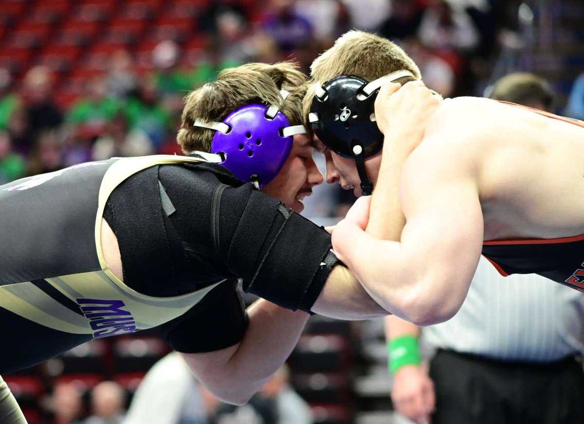 WDM Valley's Andrew Price (right) locks up with Muscatine's Evan Franke (left) during a 215-pound match at the IHSAA state tournament semifinals at Wells Fargo Arena in Des Moines on Thursday. (Photo by Ryan Timmerman)