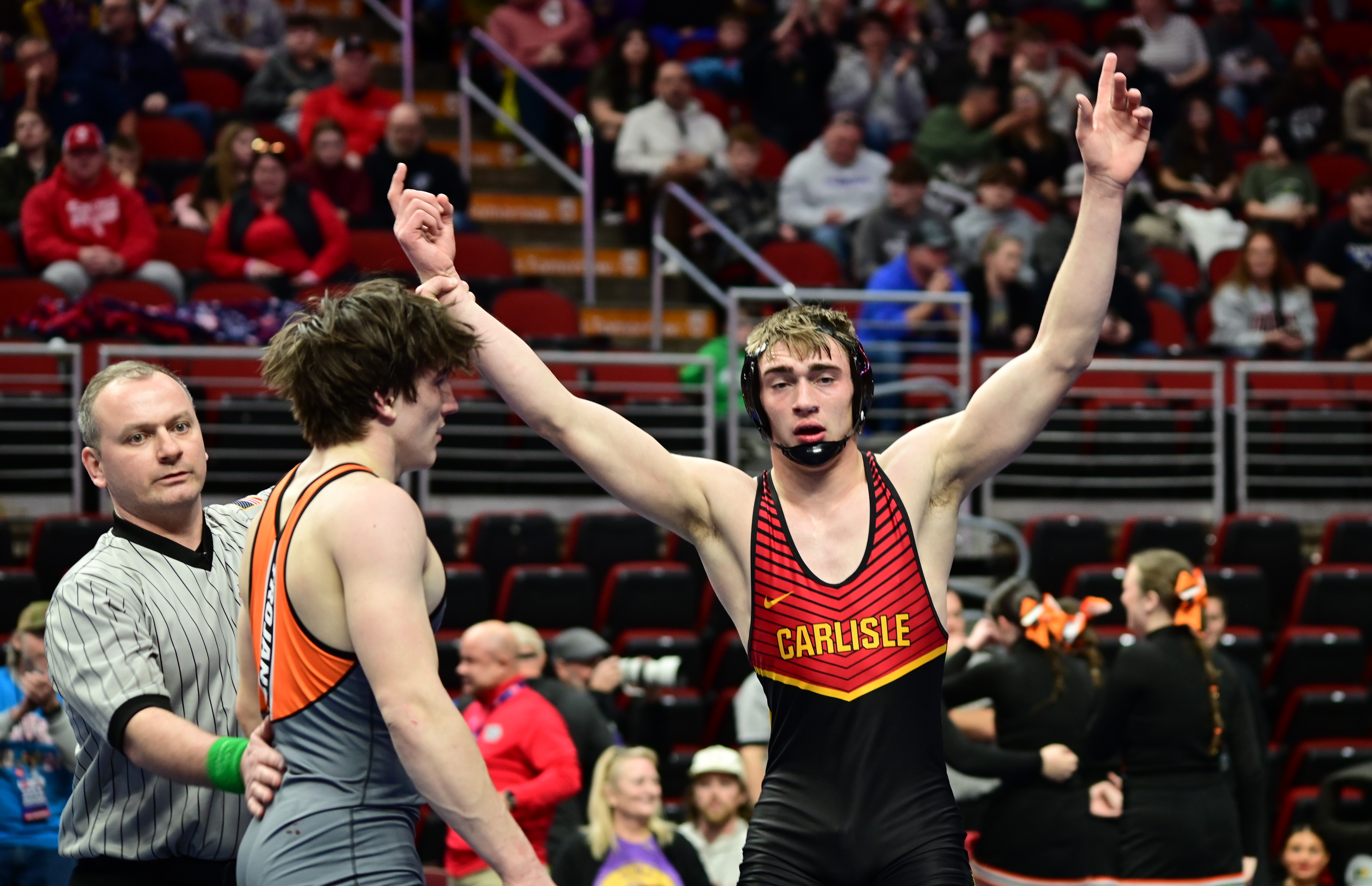 Carlisle's Asa Hemsted gets his hand raised after beating three-time state champion Maximus Magayna of Waterloo East during a Class 3A 175-pound semifinal match at the Iowa high school state wrestling tournament at Wells Fargo Arena in Des Moines on Friday. (Photo by Ryan Timmerman)