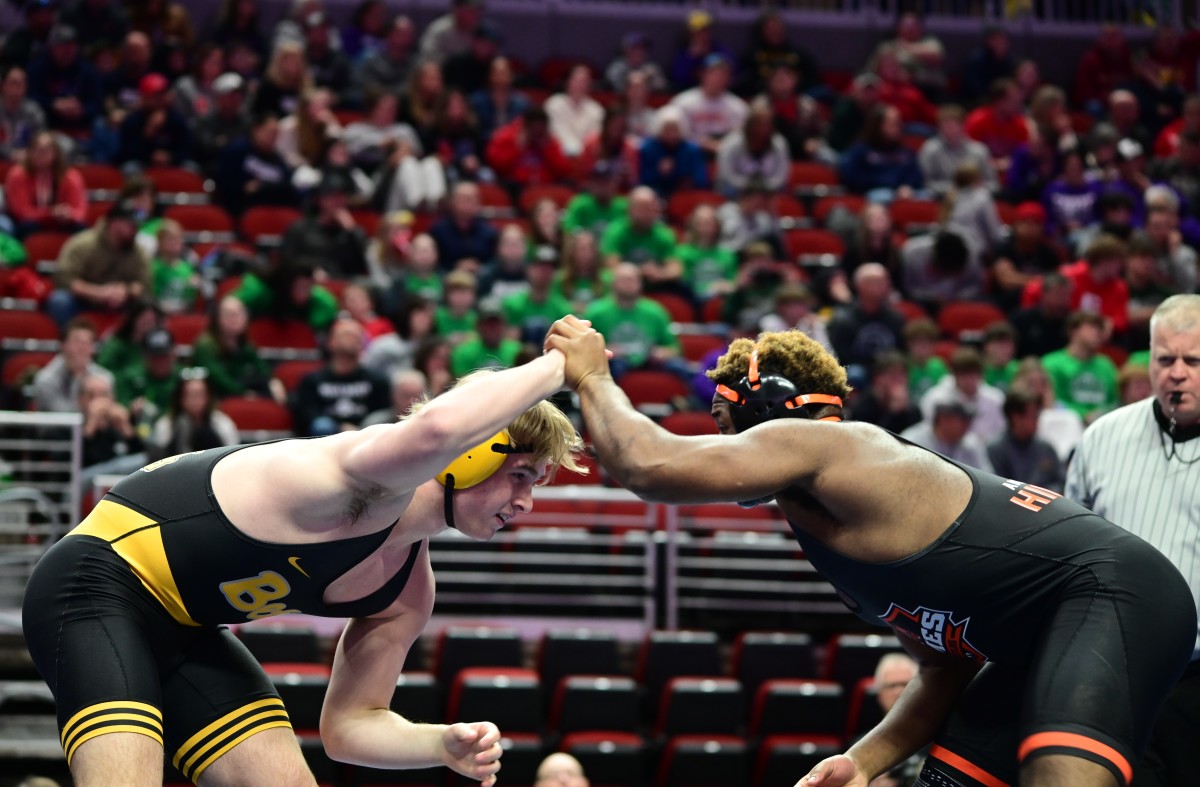 Southeast Polk's Holden Hansen lunges at Andrew Price of WDM Valley during a Class 3A semifinal match at 215 pounds at the Iowa high school state wrestling meet at Wells Fargo Arena on Friday. (Photo by Ryan Timmerman)
