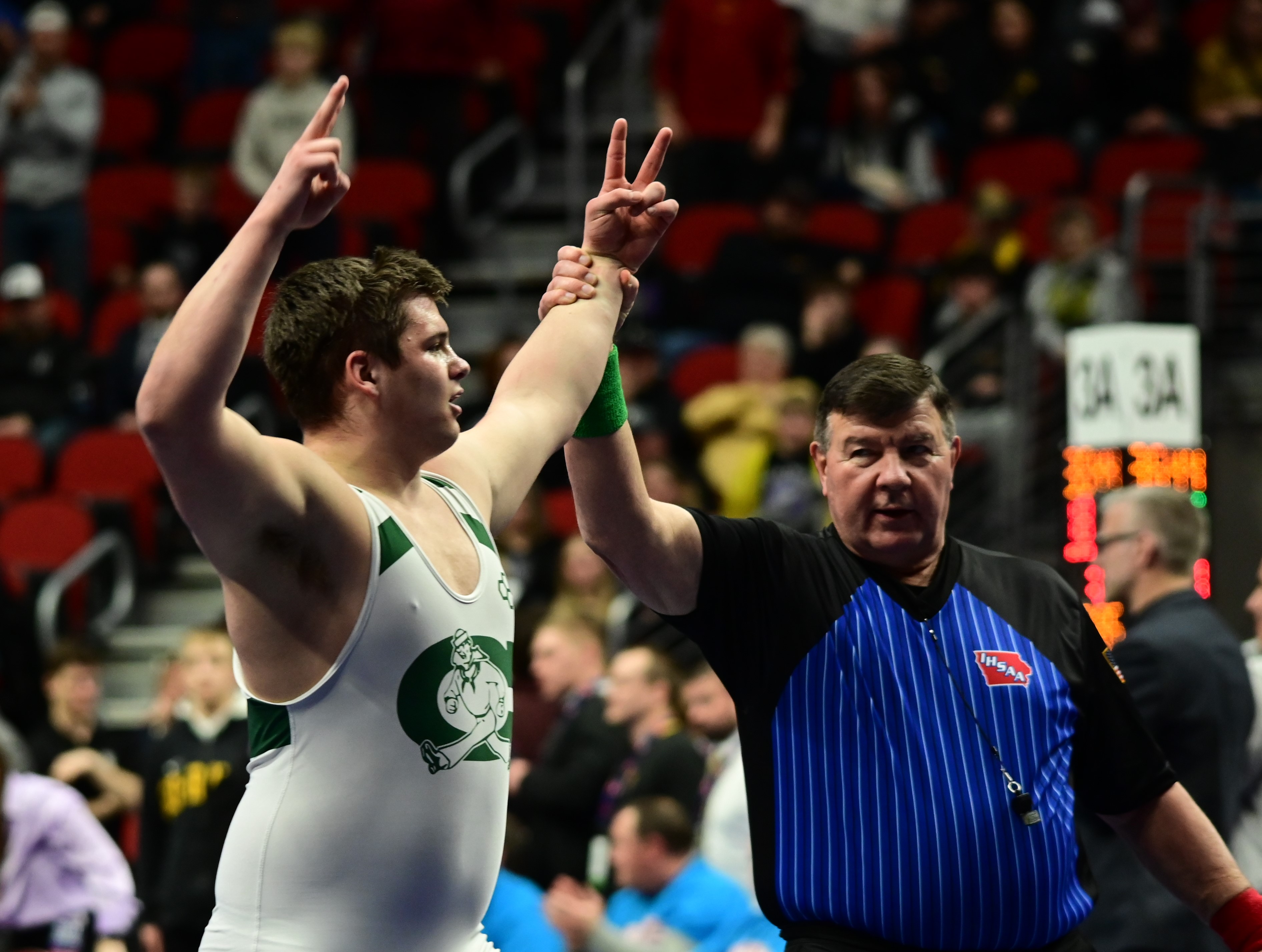 Columbus Catholic's Mason Knipp gets his hand raised after winning the Class 1A 285-pound state championship for his second consecutive state title during the Iowa high school state tournament at Wells Fargo Arena in Des Moines on Saturday. (Photo by Ryan Timmerman)