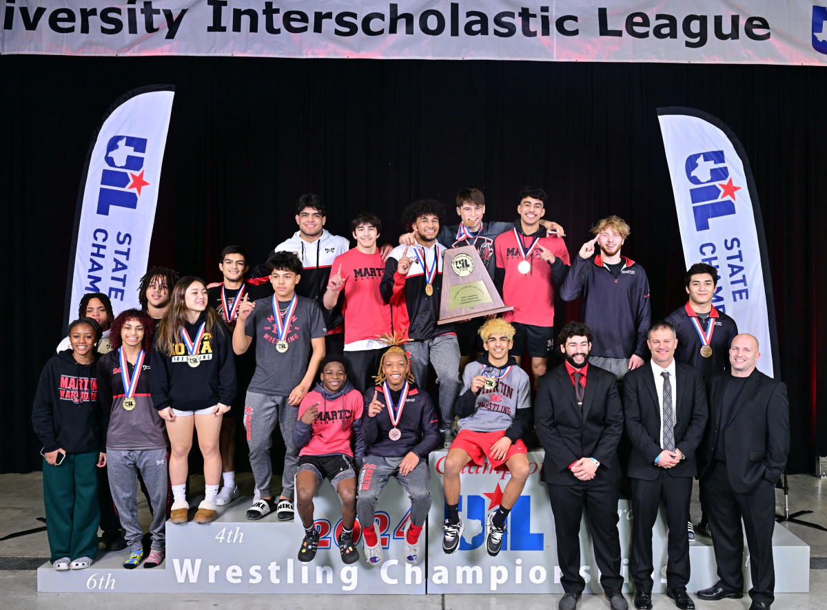 Arlington Martin poses on the podium after bringing home the Class 6A boys UIL state wrestling team title with four individual champions.