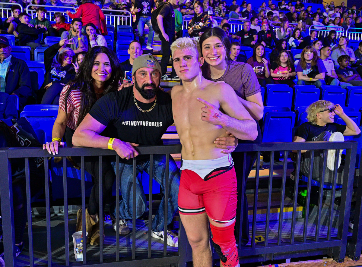 Angelo Ferrari poses with his family after winning his third high school state wrestling title on Saturday in Cypress — second UIL individual crown.