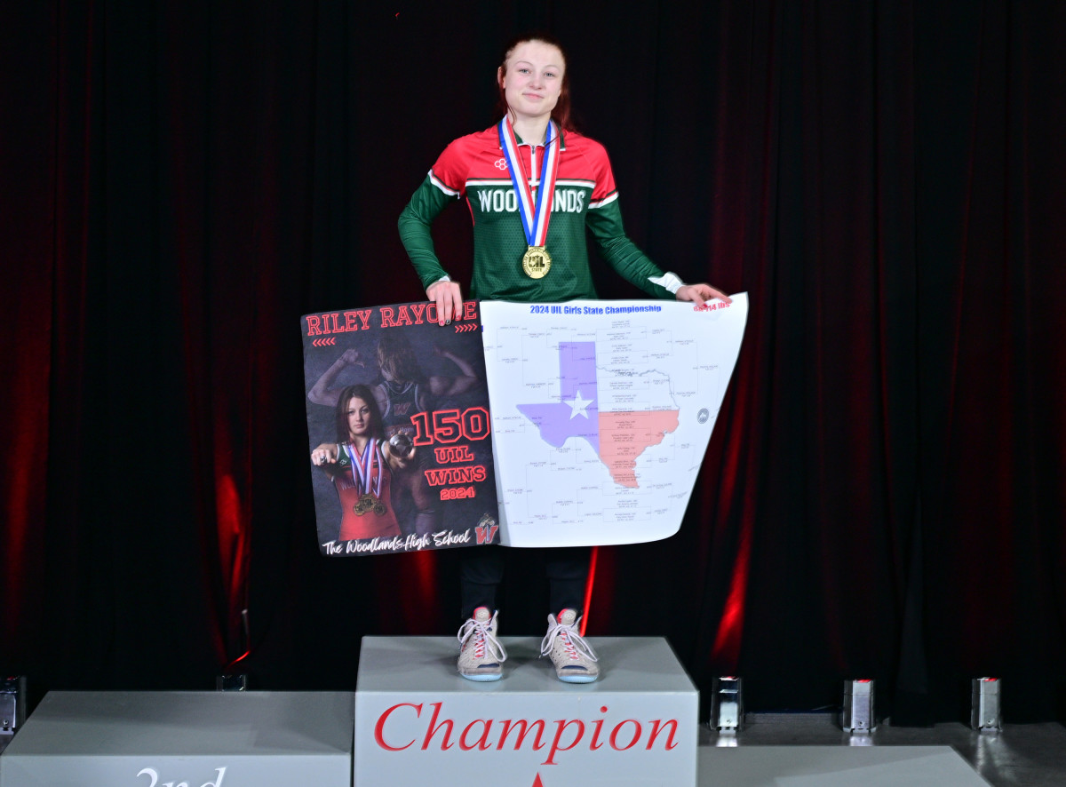 Conroe Woodlands' Riley Rayome poses atop the podium after bringing home a 6A title at 114 pounds to complete a 54-0 season.