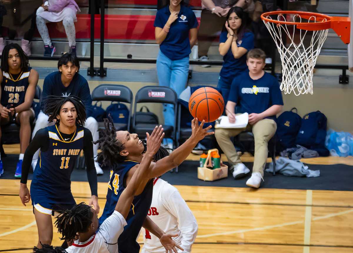 Stony Point's Davaughn Hueitt (24) attacks the rack for against the Manor Mustangs during the fourth period at the District 25-6A boys tournament.