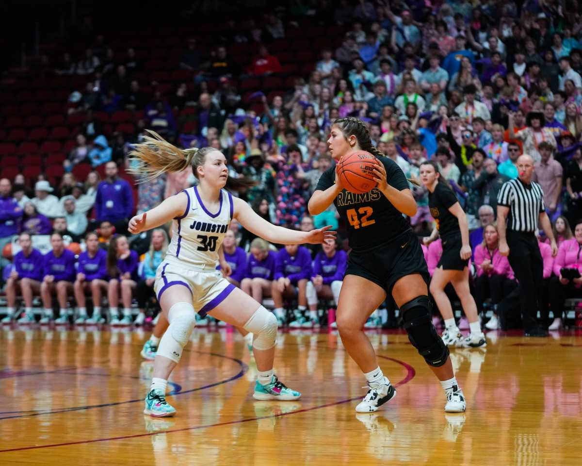 Iowa girls high school basketball: Southeast Polk forward Eva Solseth (42) looks for an open player against Johnston guard Aili Tanke (30) during the 5A quarterfinals of the Iowa high school girls state basketball tournament at Wells Fargo Arena in Des Moines
