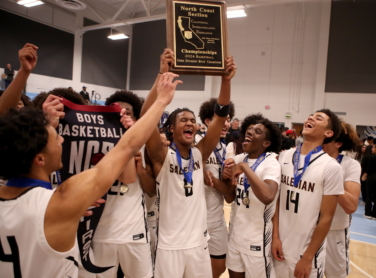 Salesian raises the trophy after winning the CIF North Coast Section Open Division championship on Feb. 23, 2024.