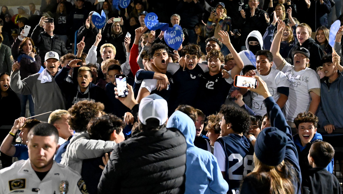 Gulliver Prep players celebrate in the stands with fans after crashing through the barriers to join family, friends and fans after winning the Class 4A boys soccer state championship on Saturday at Lake Myrtle Park in Auburndale.