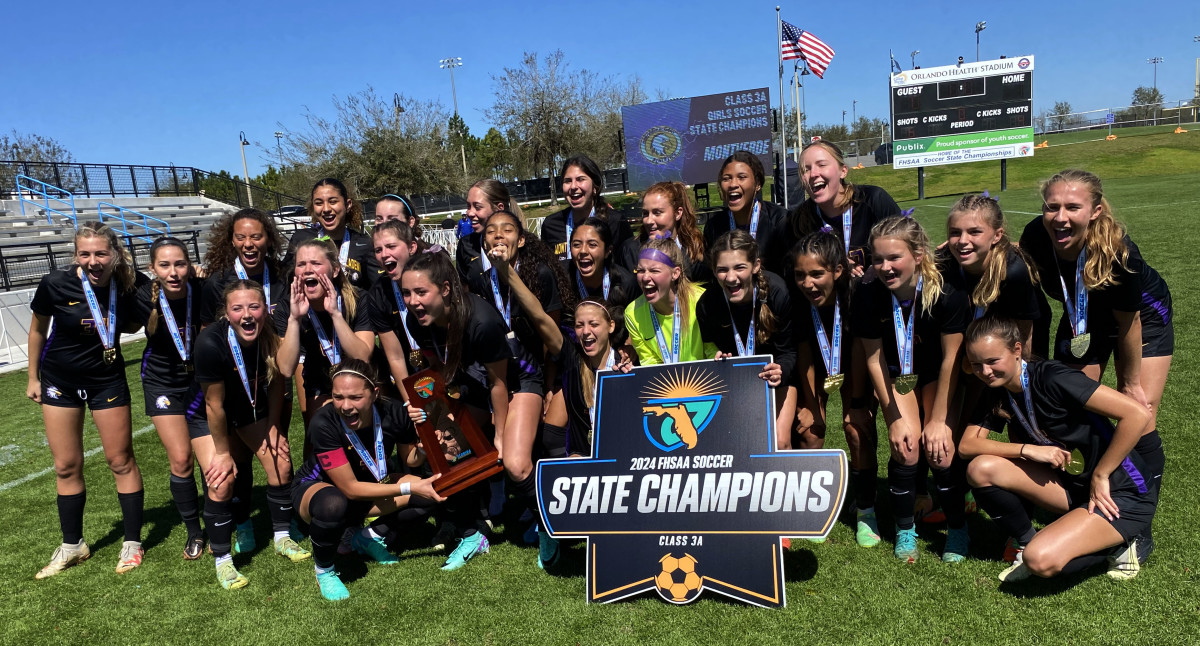 Montverde Academy girls showcase their trophy after winning the Class 3A state championship soccer title on Saturday at Lake Myrtle Park in Auburndale.
