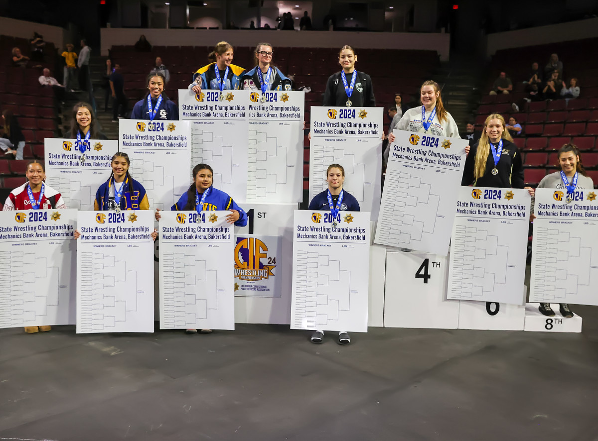 Twelve of the 14 girls state champions pose together following the grueling three-day tourney.