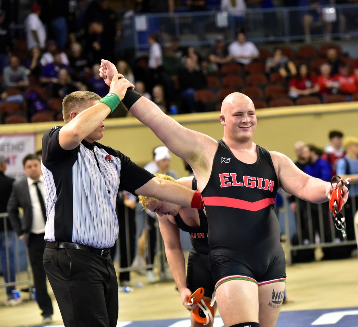 Elgin's Jace Williams gets his hand raised after winning the Class 5A 285-pound weight class title on Feb. 24, 2024. Elgin won the 5A team title, the first state championship in program history.
