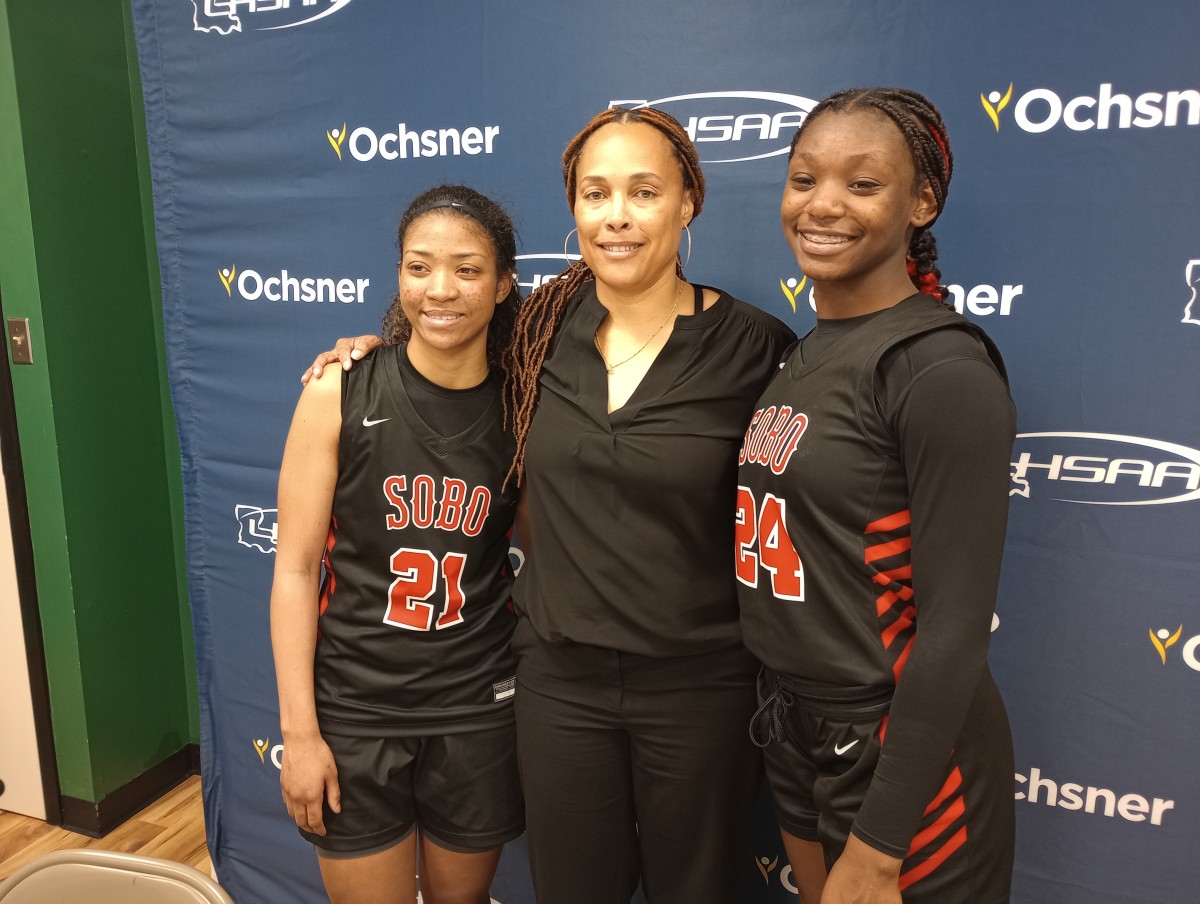 Parkway players Chloe Larry (left) and Dakota Howard pose with their coach, Gloria Williams, after the Lady Panthers' 64-63 overtime win against Walker in the Division I non-select semifinals Feb. 29, 2024.