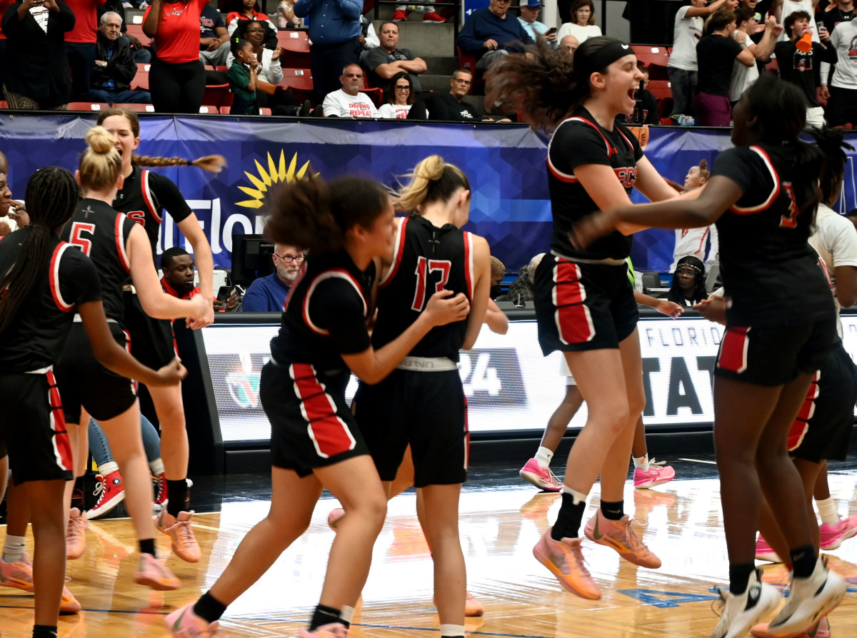 Fort Myers Evangelical Christian Academy players celebrate after winning the Class 2A girls basketball state championship on Thursday at the RP Funding Center in Lakeland.
