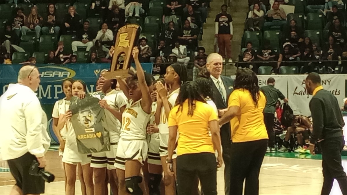 Arcadia holds up the Division IV non-select championship trophy March 1, 2024.