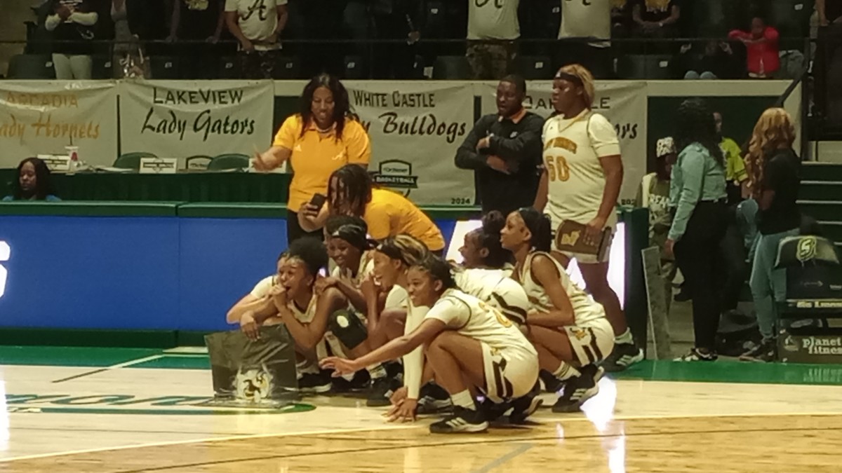 Arcadia players get set to accept the Division IV non-select championship trophy after the Lady Hornets defeated Oakdale on March 1, 2024.