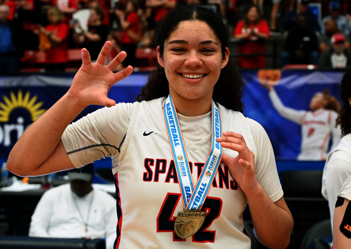 Miami Country Day senior and Baylor signee Kayla Nelms holds up her Class 3A state championship medal at the RP Funding Center in Lakeland on Friday.