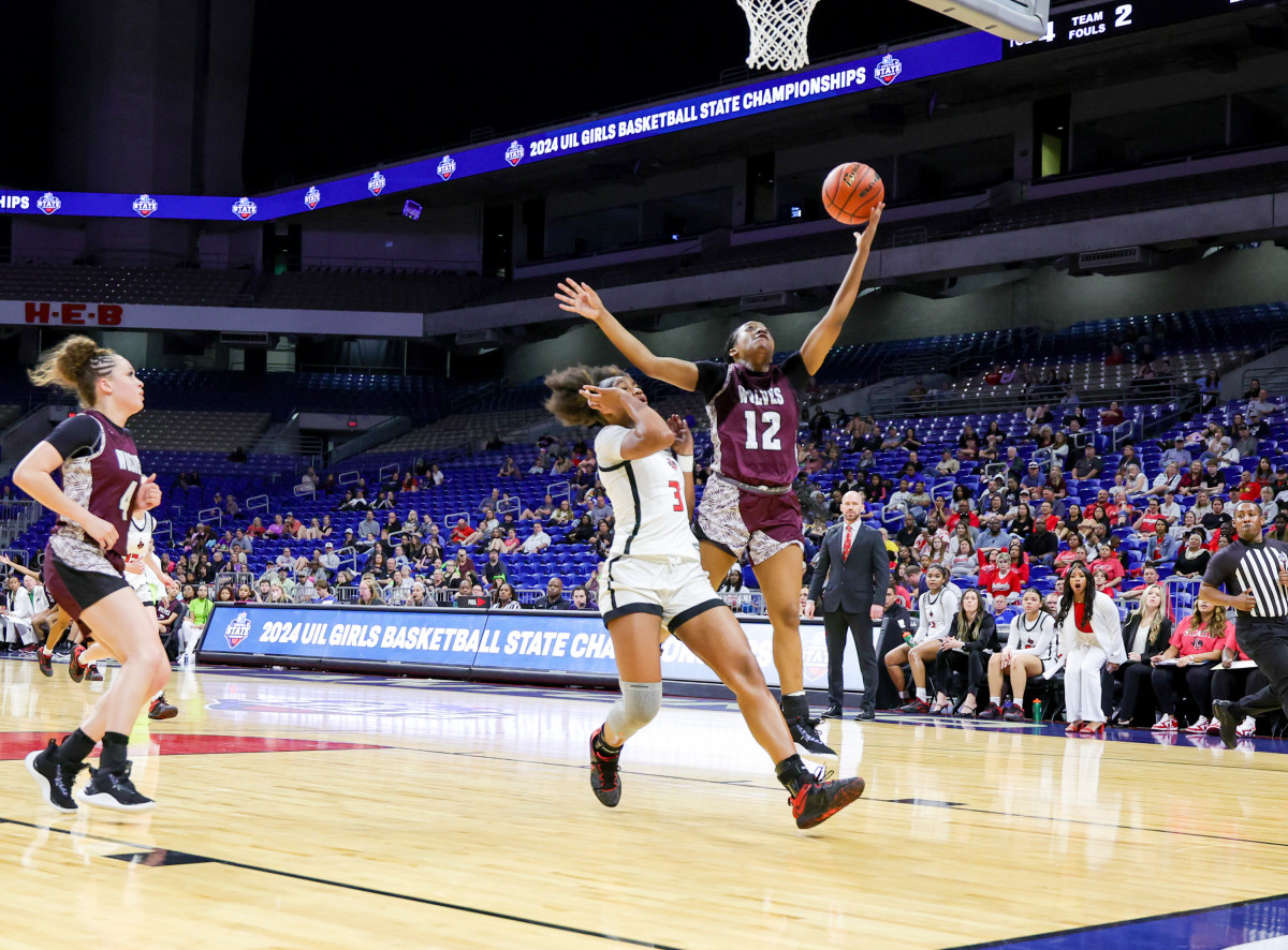 Chrishawn Coleman attempts a fast break layup over Frisco Liberty's Jacy Abii in the Class 5A UIL state girls basketball championship on Saturday at the Alamodome.