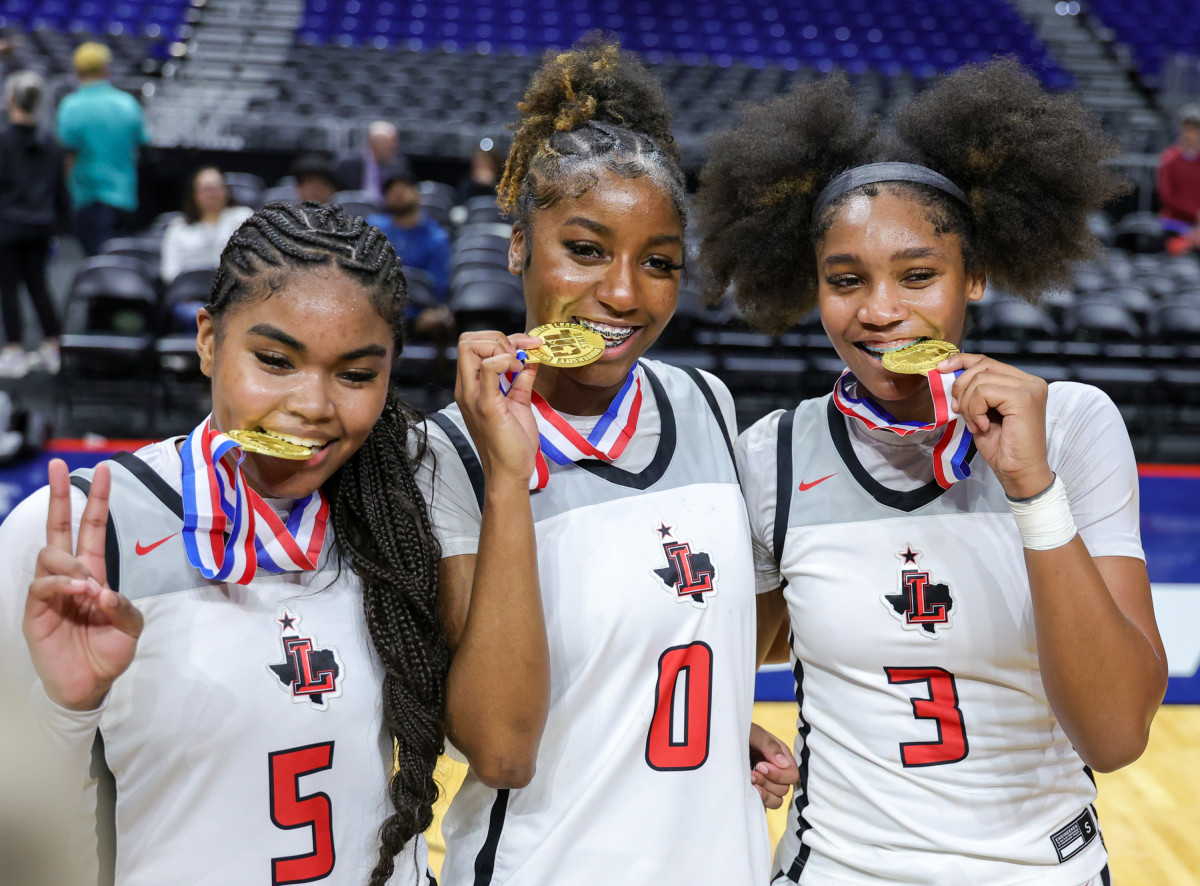 Jacy Abii (right), Frisco Liberty's star sophomore and tournament MVP, poses with Aziyah Farrier (center) and senior Keyera Roseby after upending nationally ranked Mansfield Timberview in the Class 5A title.