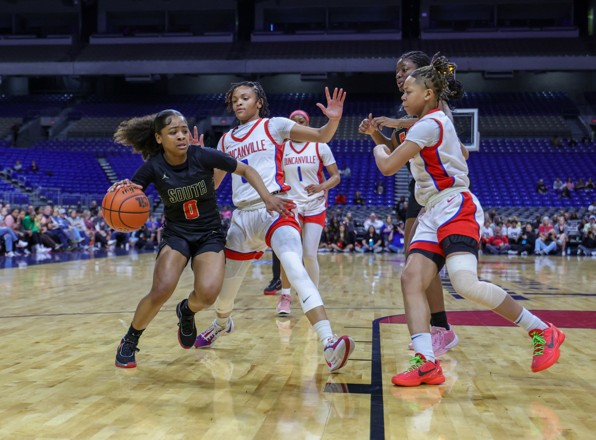 South Grand Prairie's Autum Sherman is swarmed by Duncanville defenders as she drives to the lane during the UIL Class 6A state girls basketball championship on Saturday night at the Alamodome.